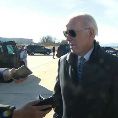 Biden speaks to press in front of a plane