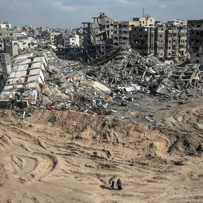 People wander through the devastated area in Gaza
