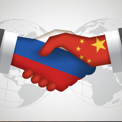 Hands with China and Russia flags shaking