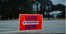 A voter ID required sign near the road