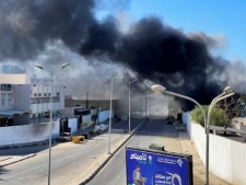 Smoke rising from a neighborhood following clashes in Tripoli