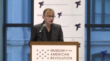 Heather S. Gregg speaking at a podium