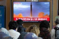 People watching Korean news on TV