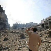 A man looking at the aftermath of a bombing