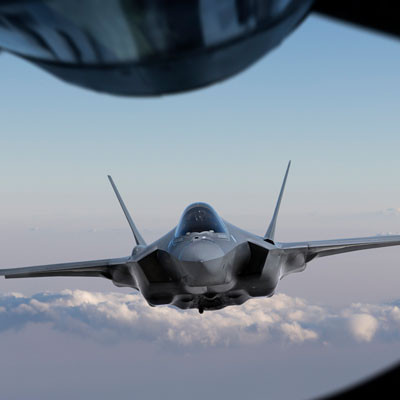 A fighter jet going to refuel in the air