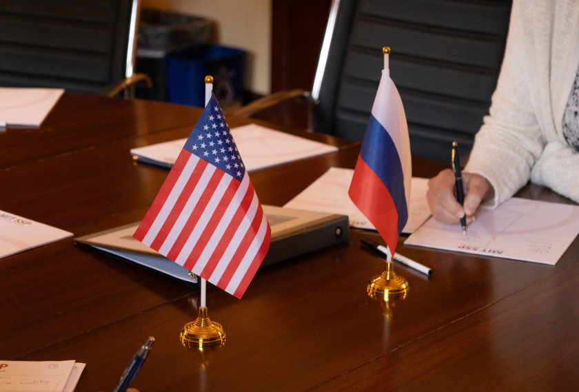 Two tabletop flags featuring the United States' flag (left) and the Russian flag (right).