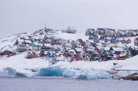 Houses covered by snow are seen from the sea in Nuuk, Greenland, on March 6, 2025.