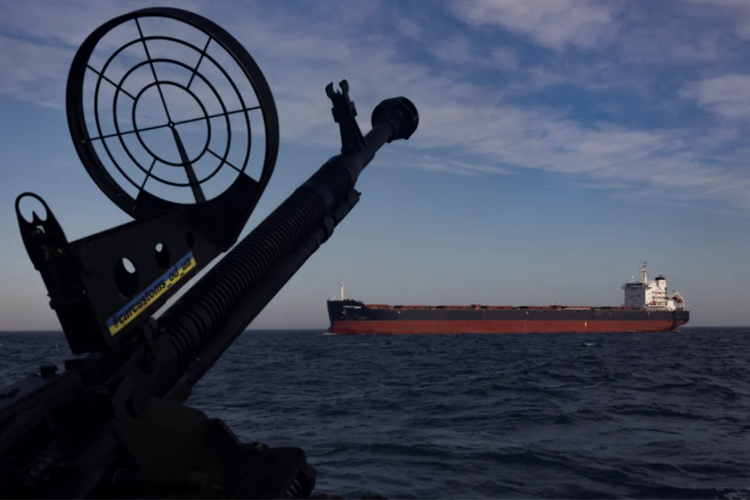 A cargo ship passing a Ukrainian patrol boat in the Black Sea, February 2024 Thomas Peter / Reuters