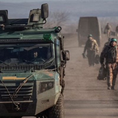 Soldiers and an armored car on a dirt road