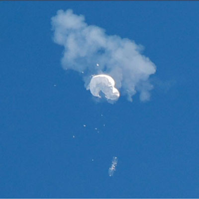 The suspected Chinese spy balloon drifts to the ocean after being shot down