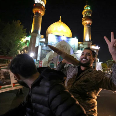 A demonstrator holds a replica missile shell as people gather in support of Iran&#039;s attack on Israel in Tehran&#039;s Palestine Square 