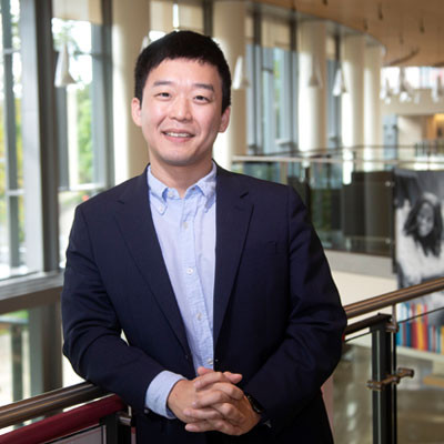 James Kim posing by inside balcony