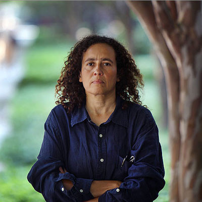 Neta Crawford standing with arms crossed