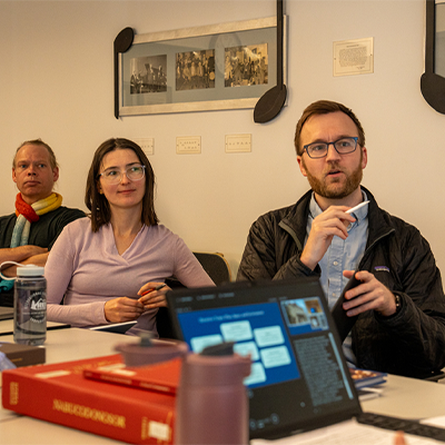 Political scientists Rich Nielsen and Volha Charnysh and philosopher Kevin Dorst (seated, from left) discuss music professor Emily Richmond Pollock's (foreground) project. Each is a member of the inaugural SHASS Faculty Fellows cohort. Photo Credits : Hanley Valentin