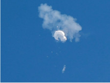 The suspected Chinese spy balloon drifts to the ocean after being shot down