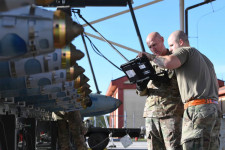 Members of the military examining equipment