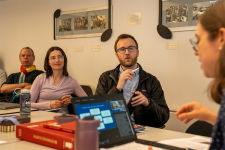 Political scientists Rich Nielsen and Volha Charnysh and philosopher Kevin Dorst (seated, from left) discuss music professor Emily Richmond Pollock's (foreground) project. Each is a member of the inaugural SHASS Faculty Fellows cohort. Photo Credits : Hanley Valentin