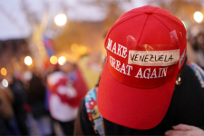 OPSHOT - A protester wears a modified 'Make America Great Again' (MAGA) hat with 'Venezuela' taped over the original text during a demonstration in support of the Venezuelan people following the US military operation in Venezuela to capture the Venezuelan president, in Barcelona on January 4, 2026. Venezuela's president Nicolas Maduro was in a New York jail today after a shock US snatch-and-grab raid to remove him from power and assert Washington's control over the oil-rich South American nation.